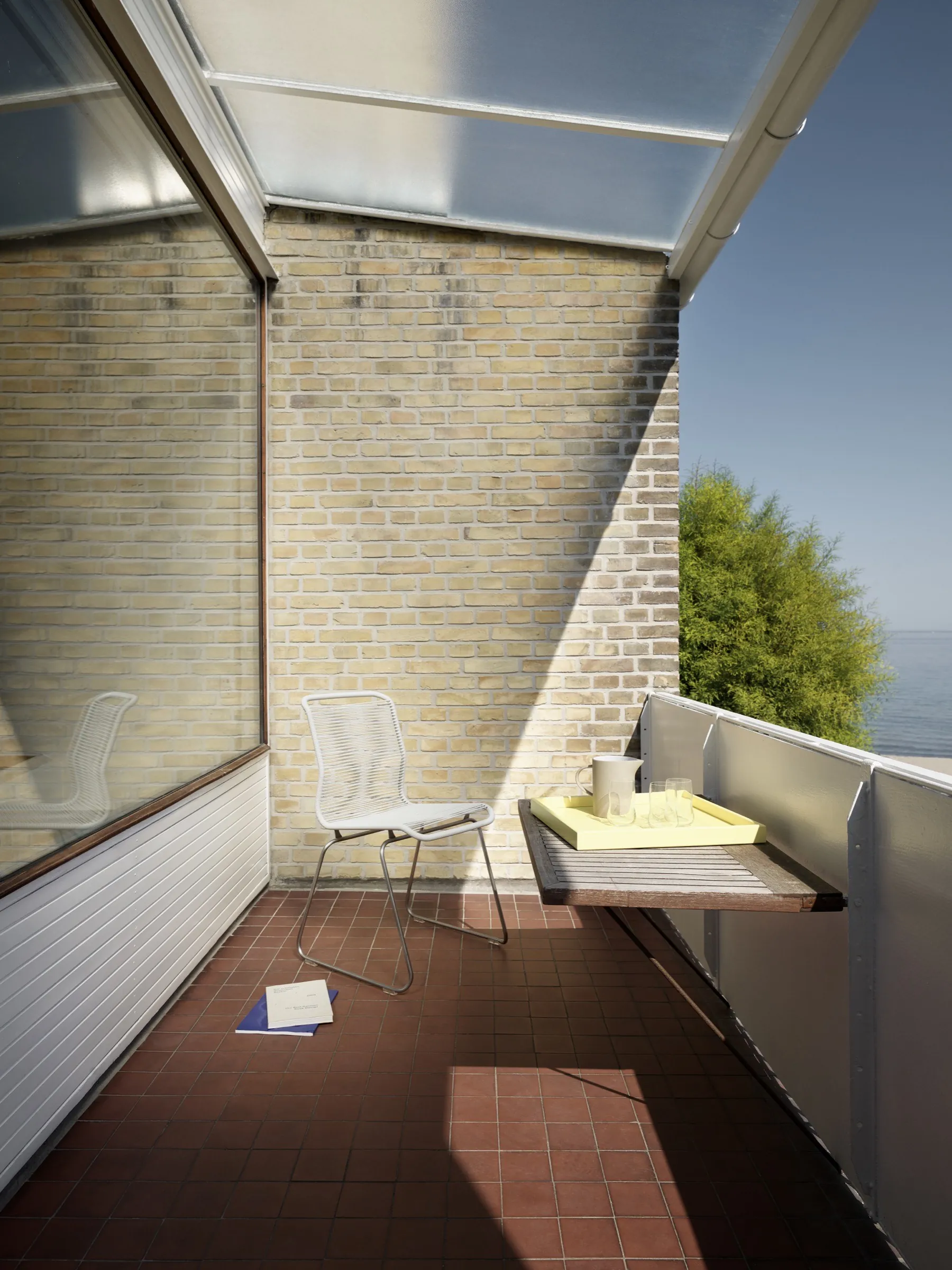 AJ House dining vignette with Panton chairs and stainless Duke table.
